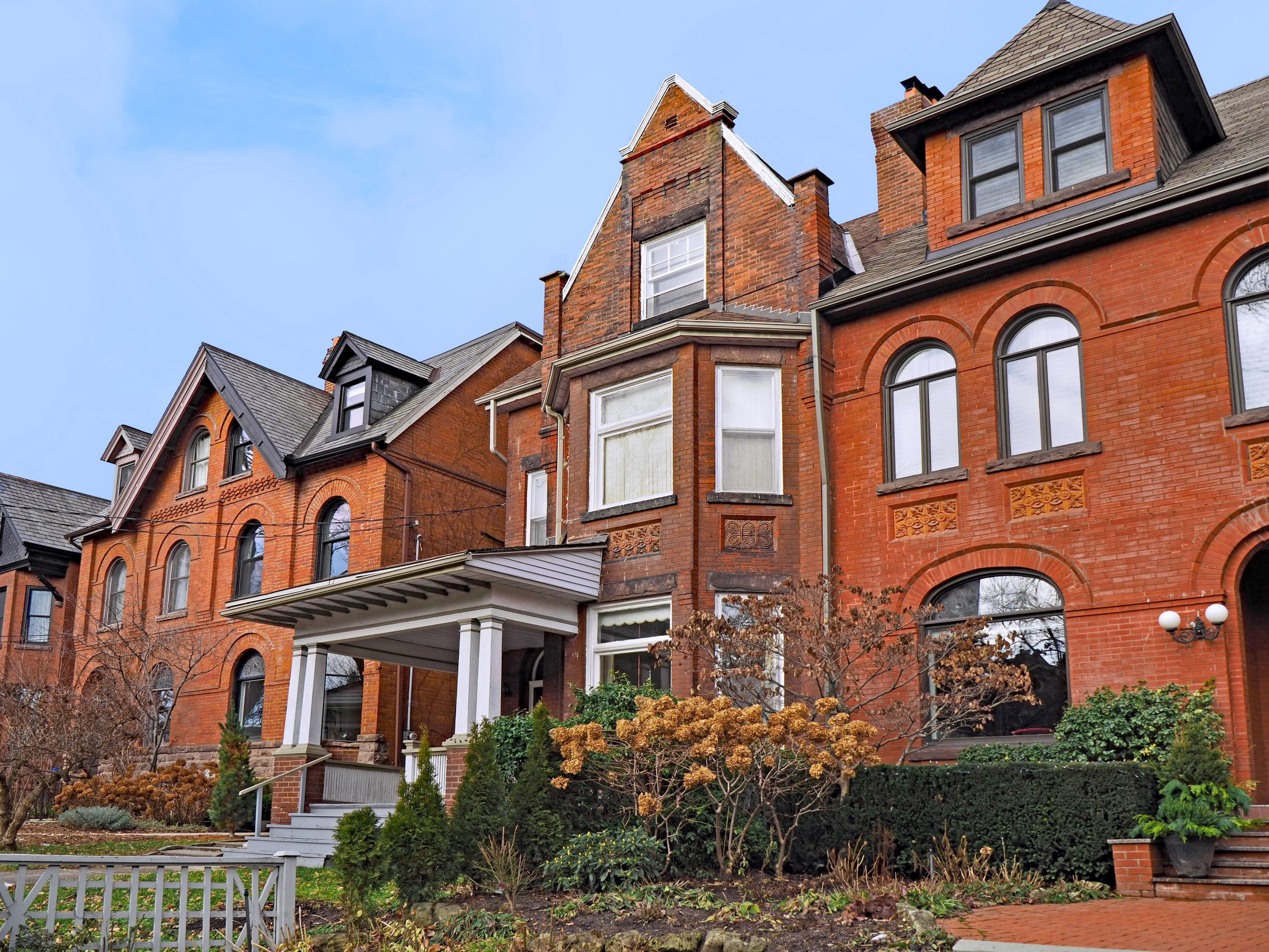 large brick Victorian houses with gables and dormer windows